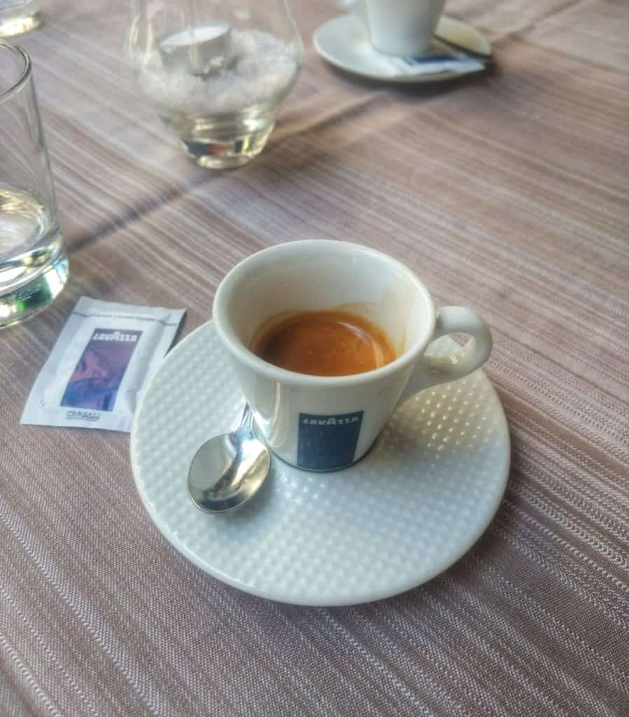 Italian espresso in a small white cup with saucer.