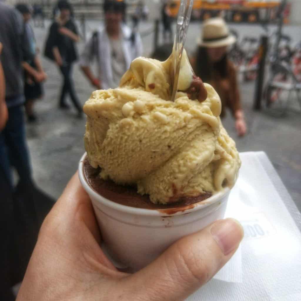 Two scoops of Italian gelato in a white plastic cup.