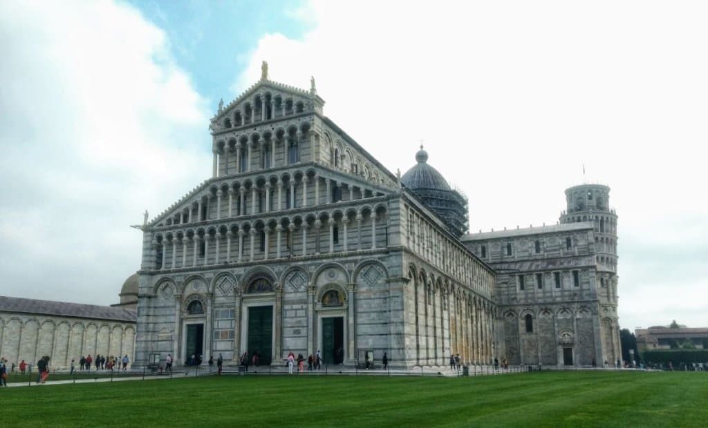 large marble cathedral with the leaning tower visible in the background