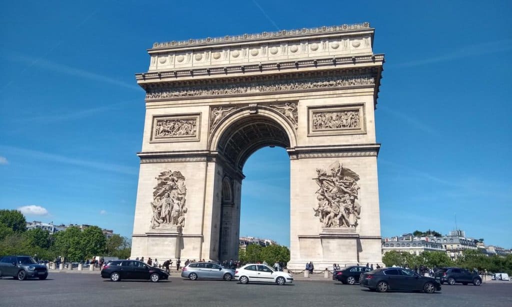 Arc de Triomphe in Paris with tourists and cars