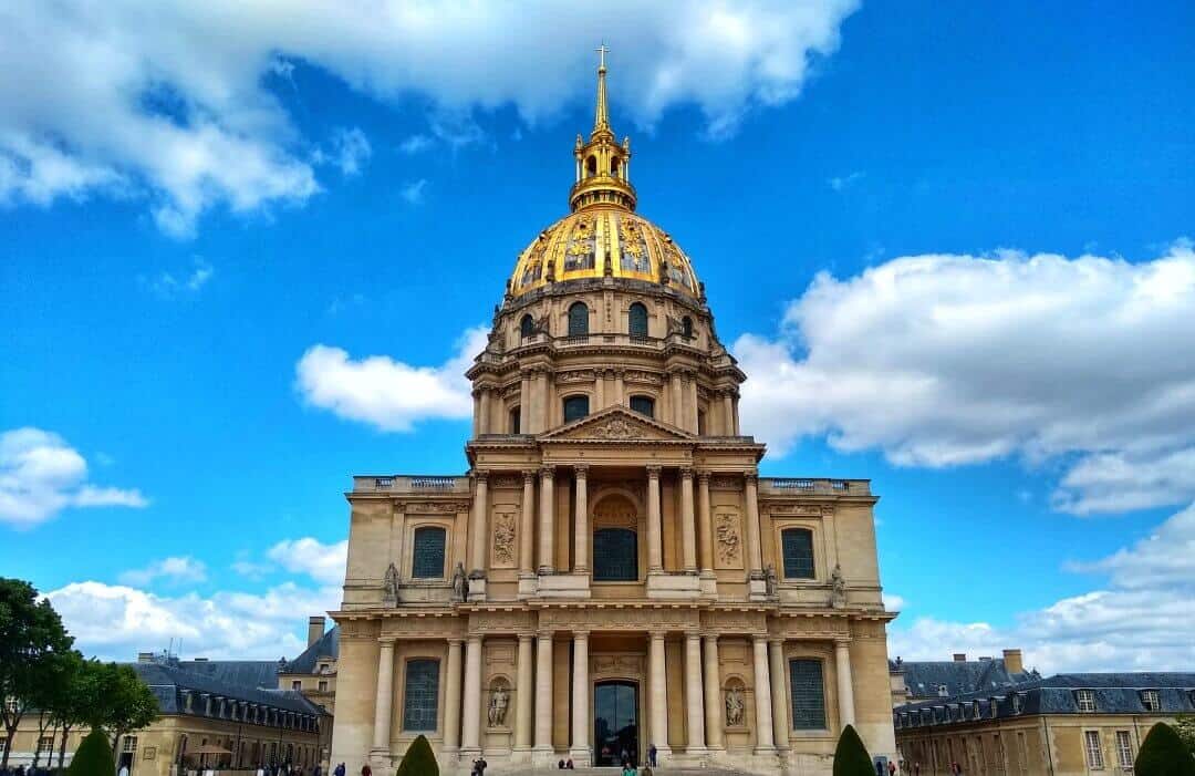 Large 19th Century building in Paris with a gold dome.