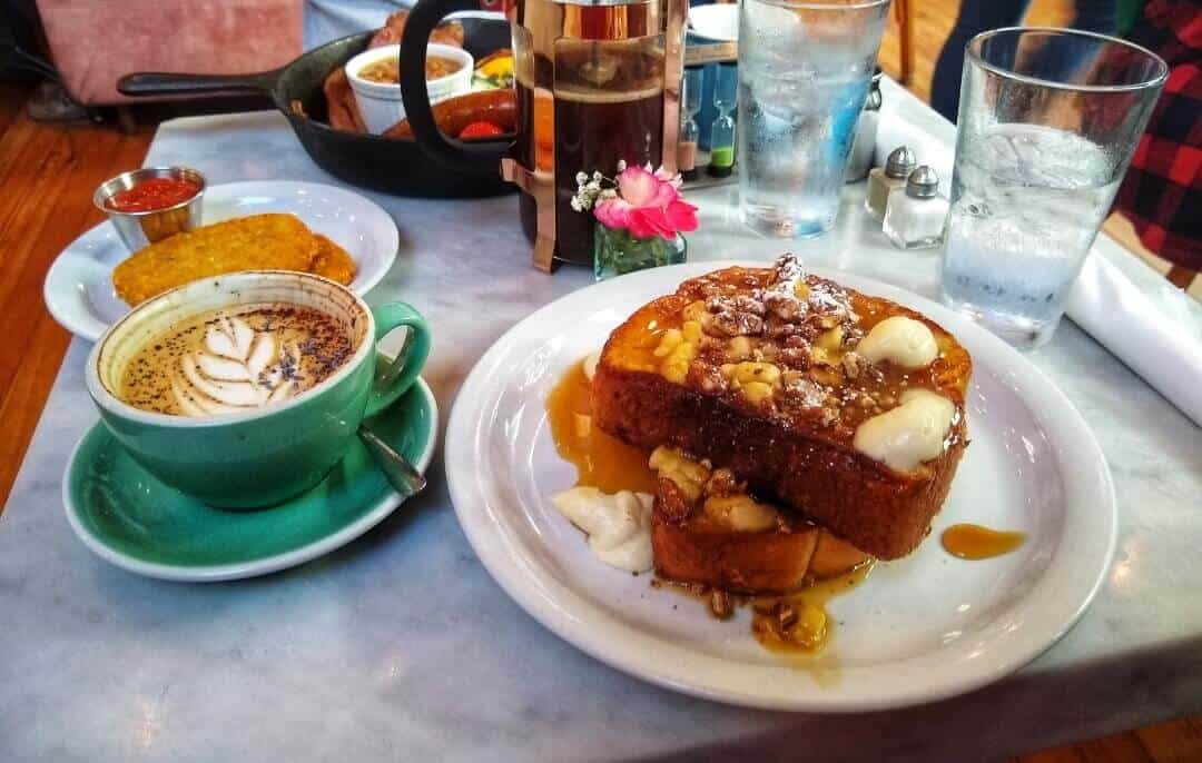Breakfast and coffee laid out on a table for two