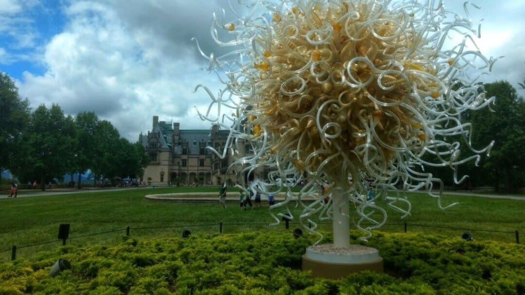 Front view of Biltmore House with a large Dale Chihuly sculpture