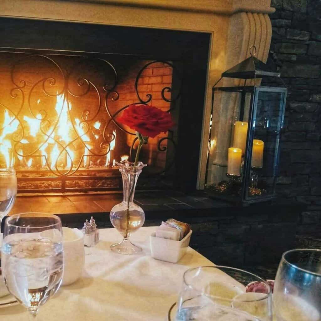 Restaurant table in front of a cozy fire.