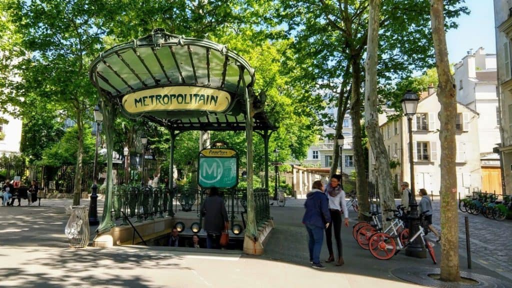 Paris metro station with a decorative green and glass cover.