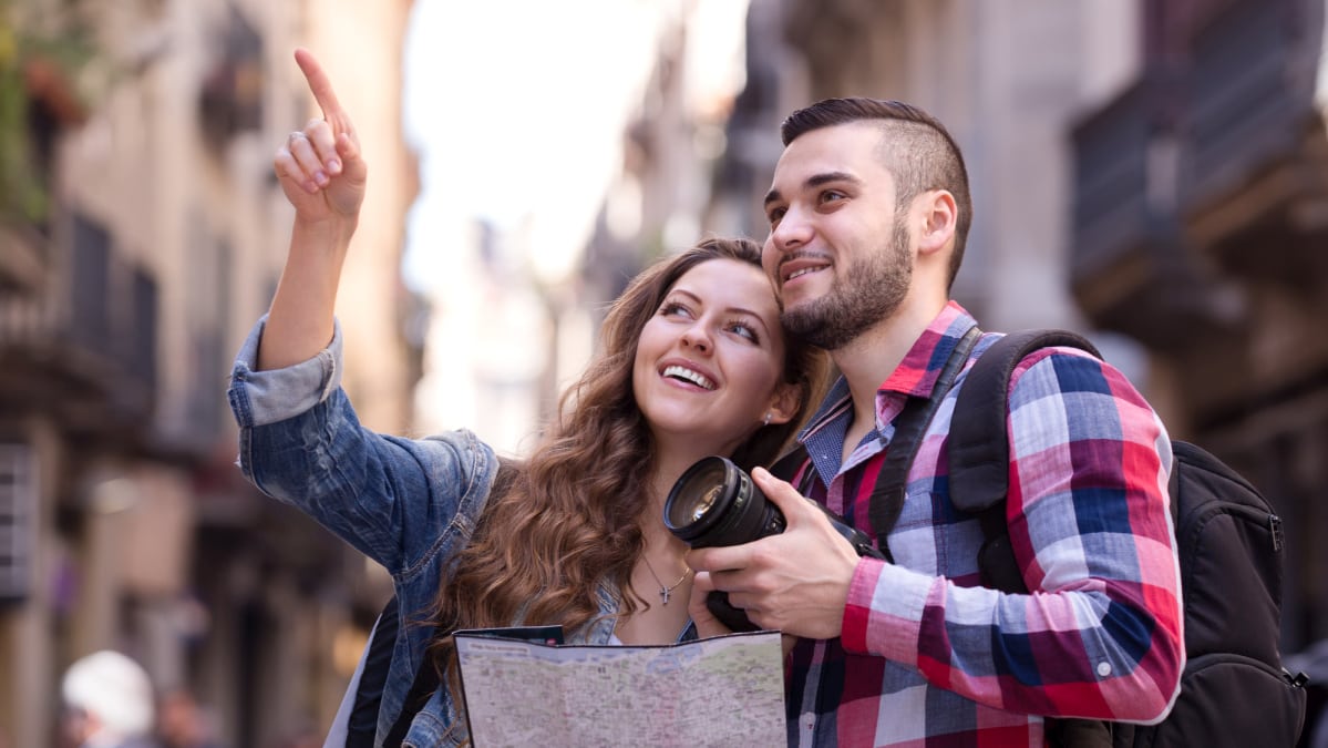 Happy tourists enjoying excursion over European town seeing sights and taking pictures on a day trip