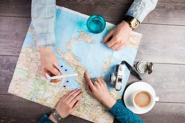 couple using a map while planning a trip