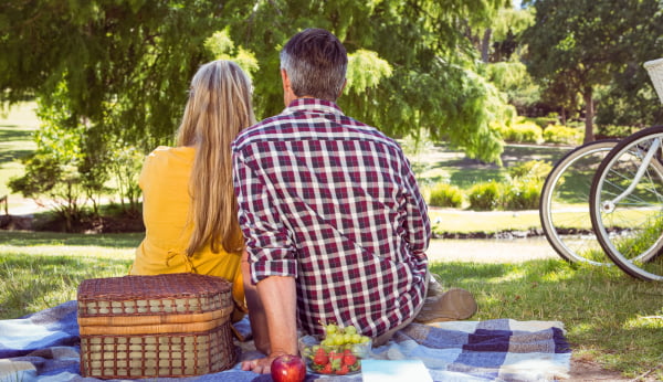 Couple having picnic in the park on a sunny day