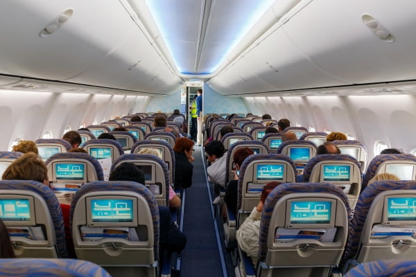 Passengers sitting on their seats in airplane cabin