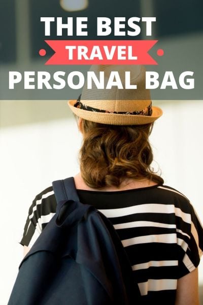 Woman in a hat with a personal carry-on bag checking the flight board at the airport.