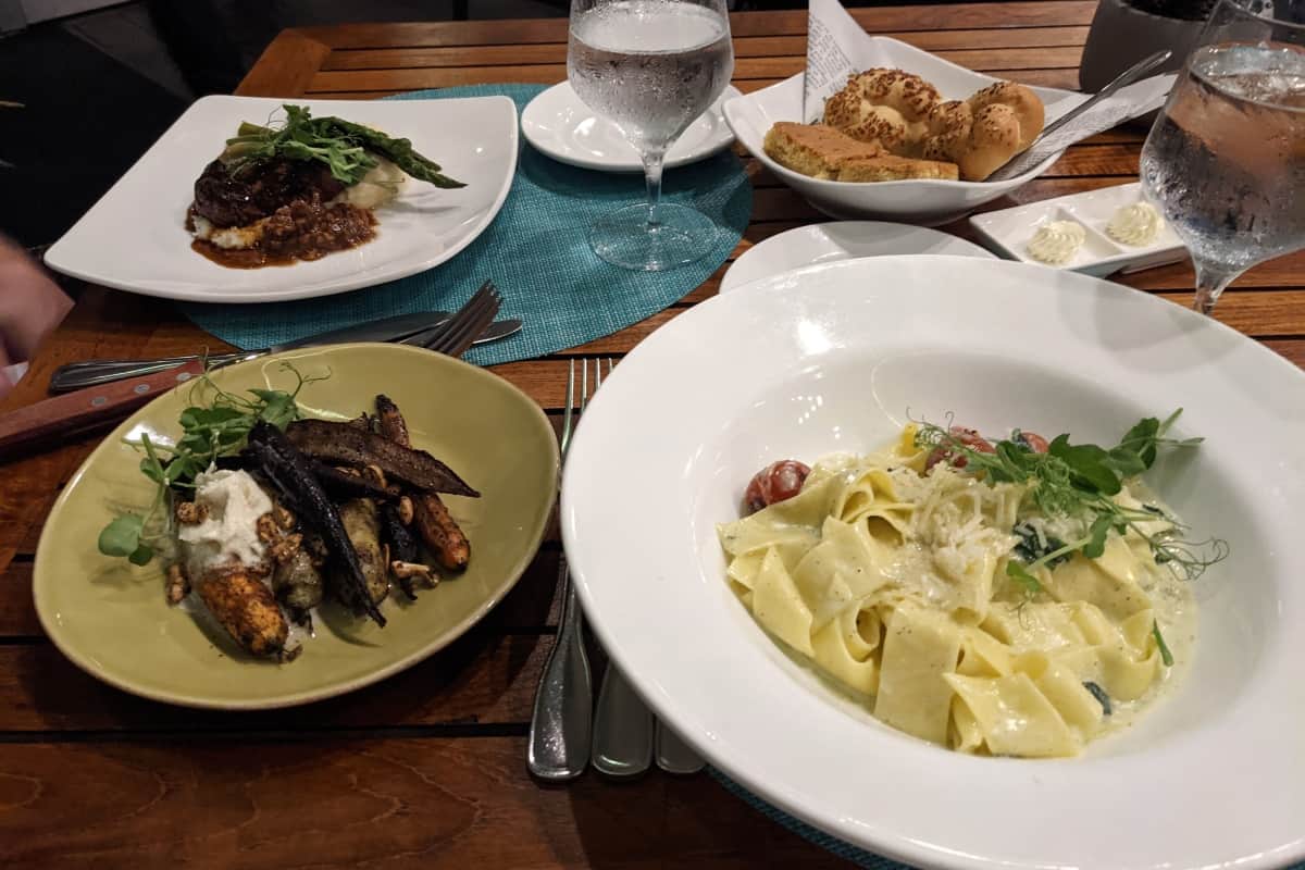 plates of food on a wooden table at Surfing Deer restaurant