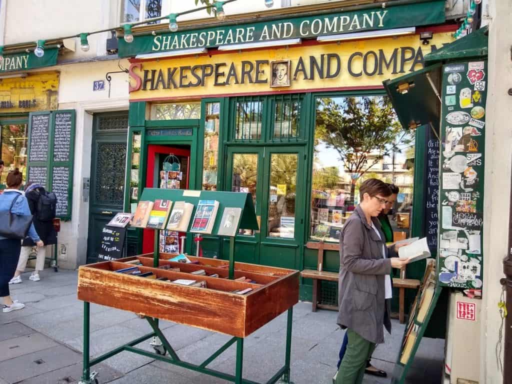 people browsing books in front of the Shakespeare and Company bookstore in Paris