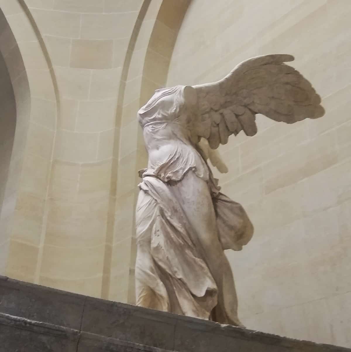 the ancient marble Winged Victory sculpture at the Louvre