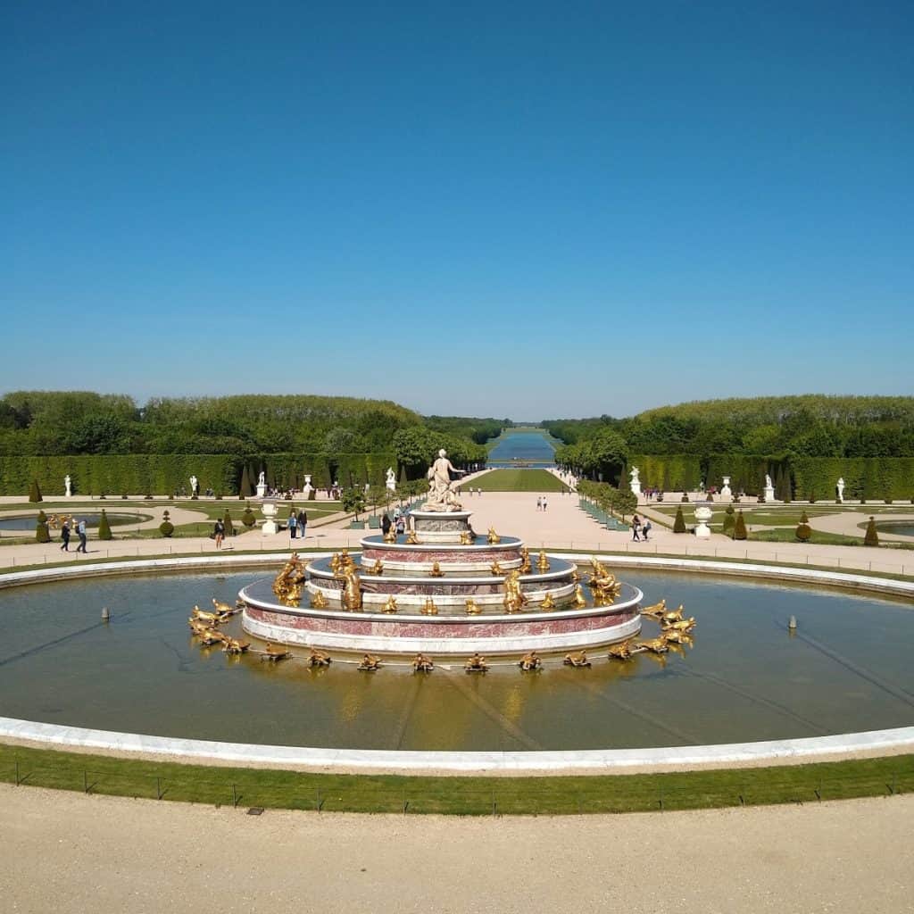 a large fountain in a grand garden at Versailles