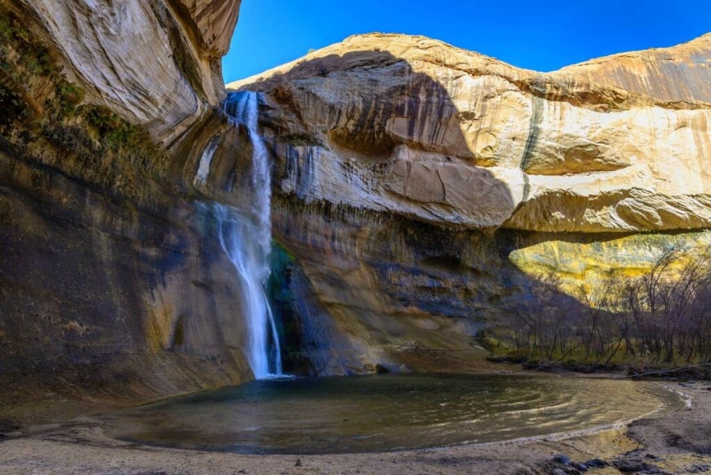 waterfall cascading into a small pool at Grand Staircase Escalante