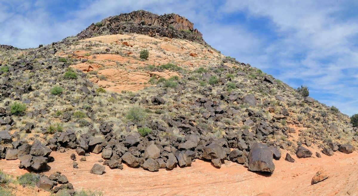 red sandy hill with ricks and scrubby vegetation