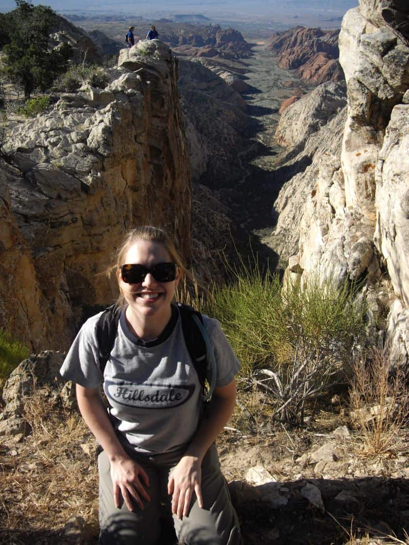 the author kneeling at a scenic overlook at Snow Canyon State Park