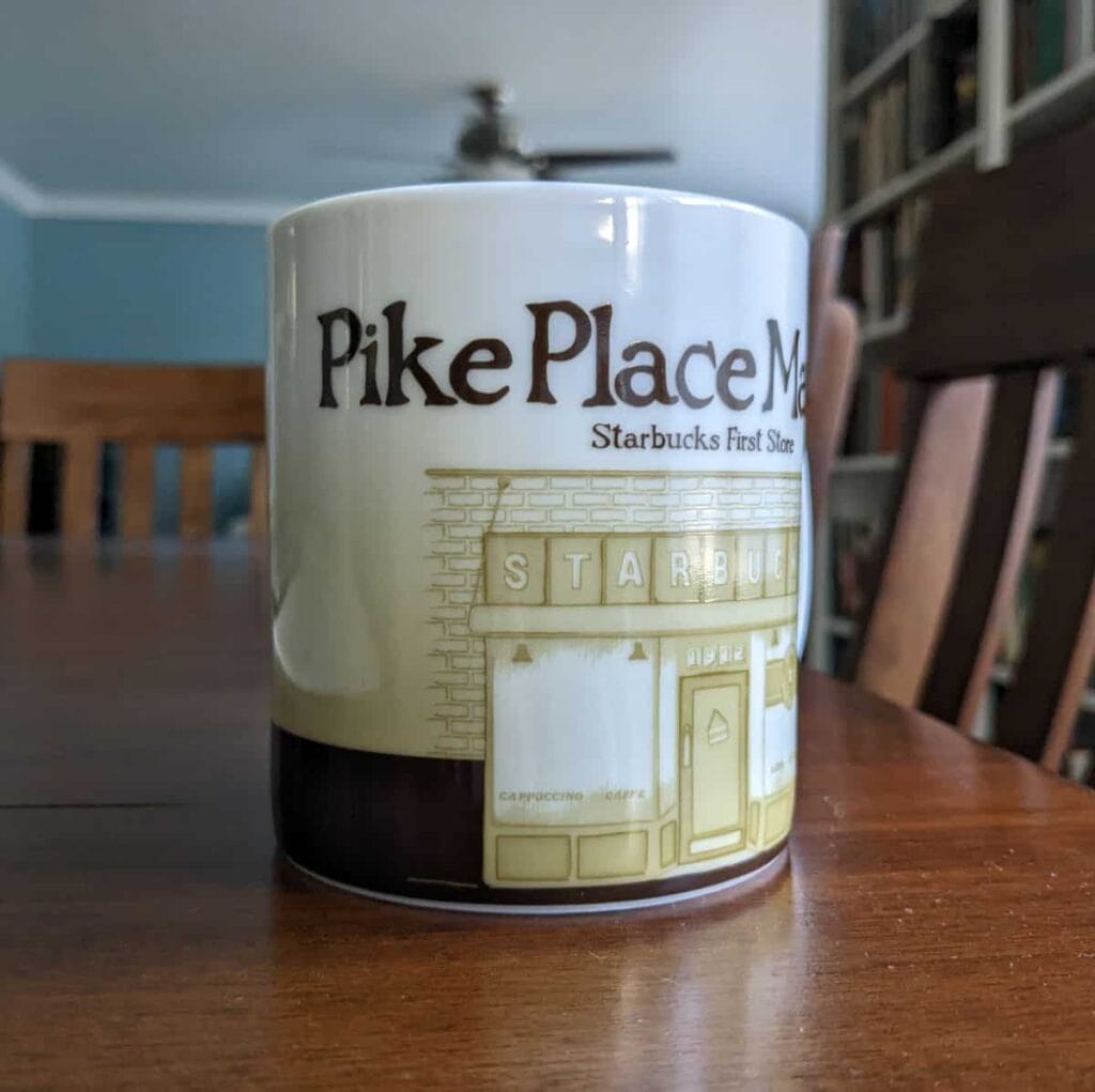 Pike Place Market Starbucks mug sitting on a wood table