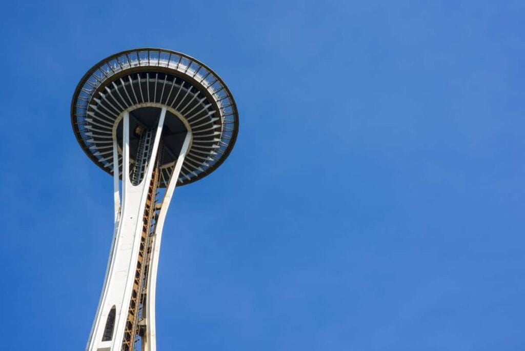 view of the Space Needle in Seattle from below against a clear blue sky