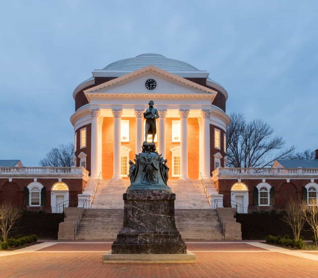 statue of Thomas Jefferson in front of a large domed brick building