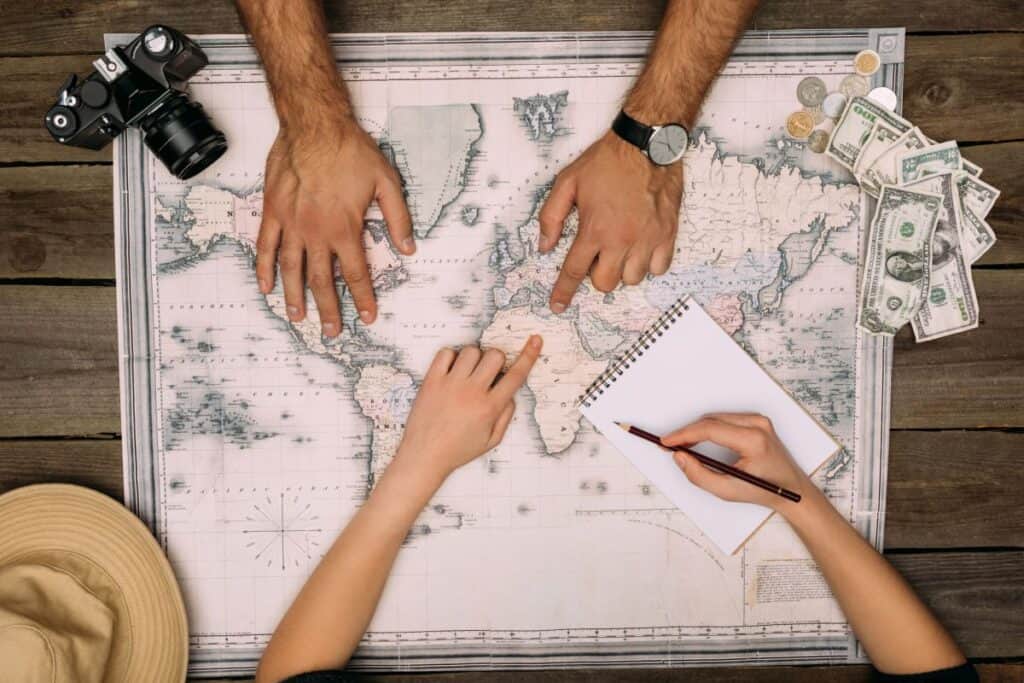 overhead view of a couple using a map to plan a trip
