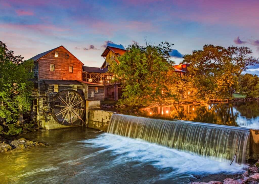 old wooden mill on a river at sunset