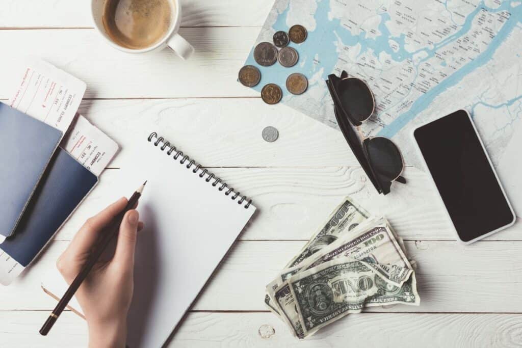 woman planning trip with a map and notebook