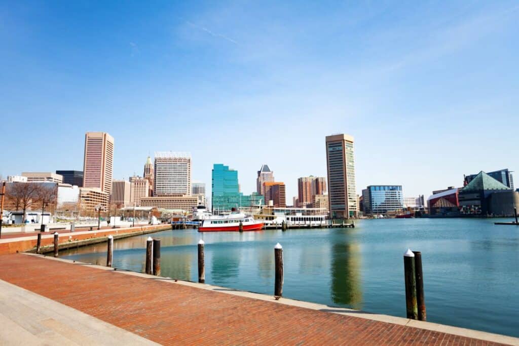 Panoramic view of Baltimore Inner Harbor marina and skyscrapers against blue sky