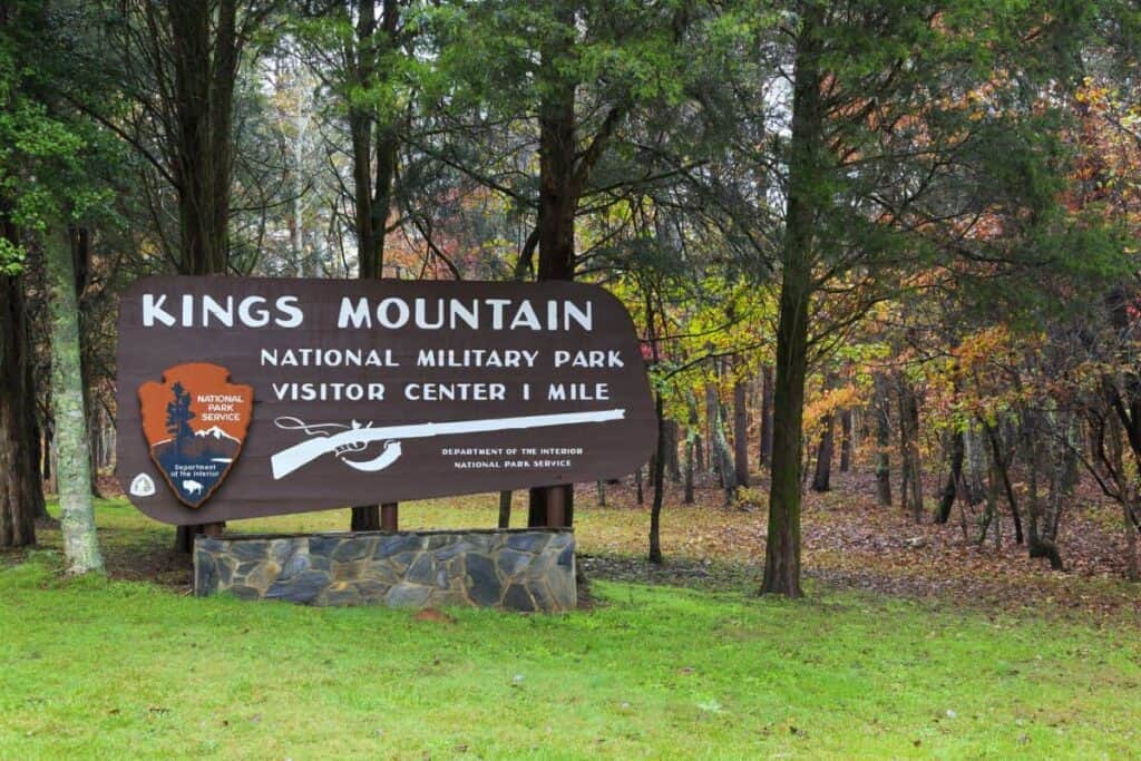 National Park service sign that says Kings Mountain National Military Park Visitor Center 1 mile