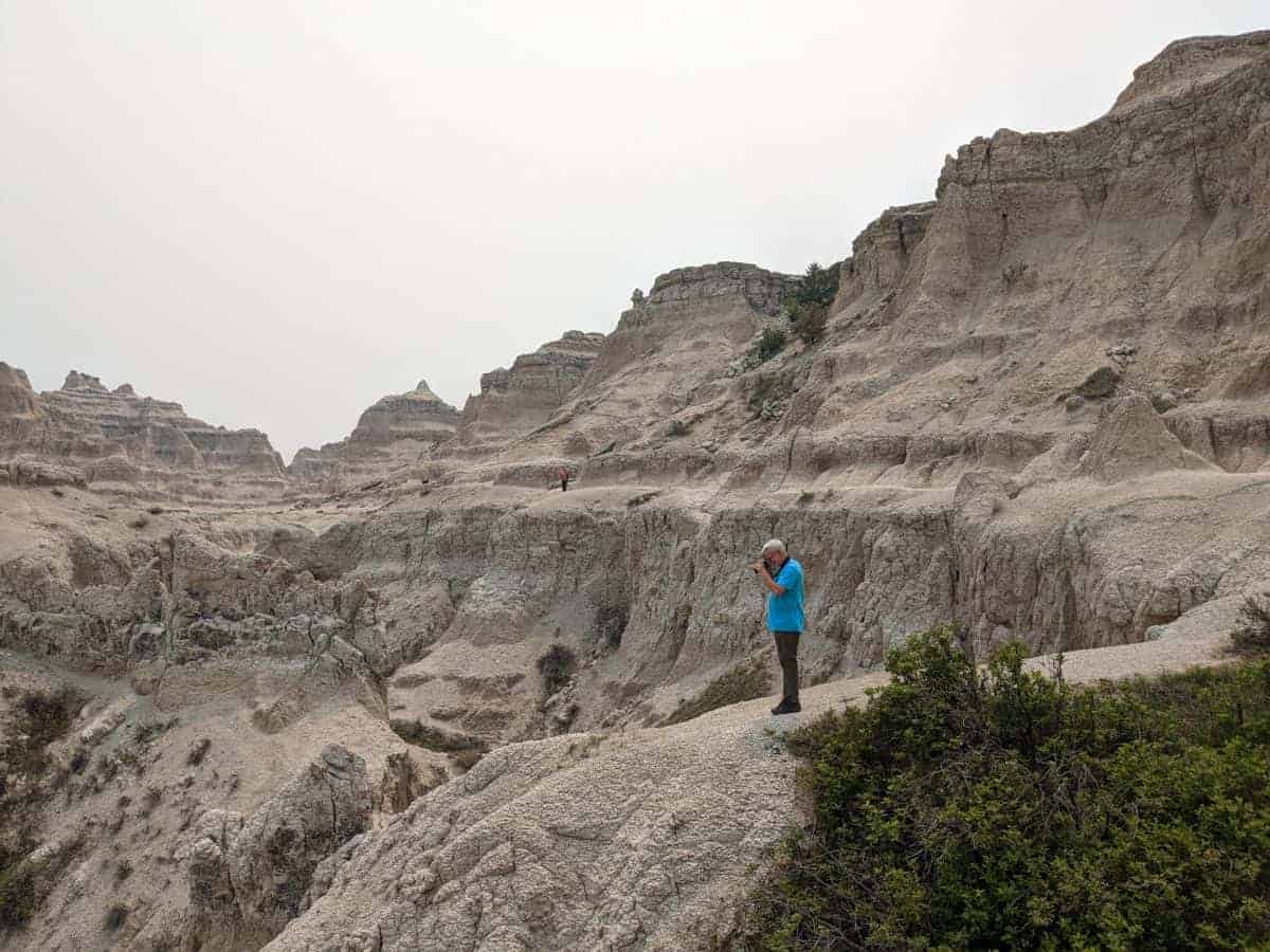 Man taking a photo from the Notch Trail upper path.