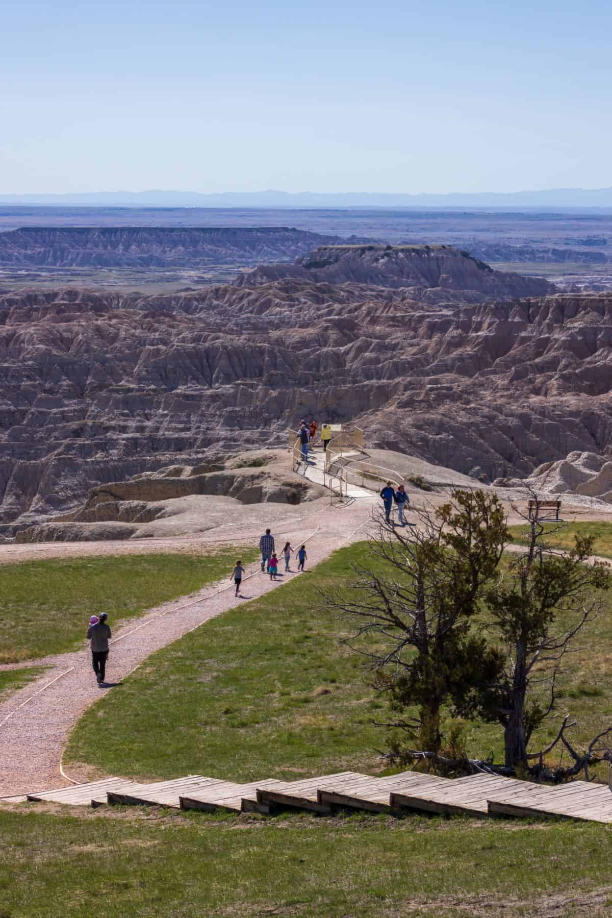 several tourists milling around the Pinnacles Overlook in Badlands National Park