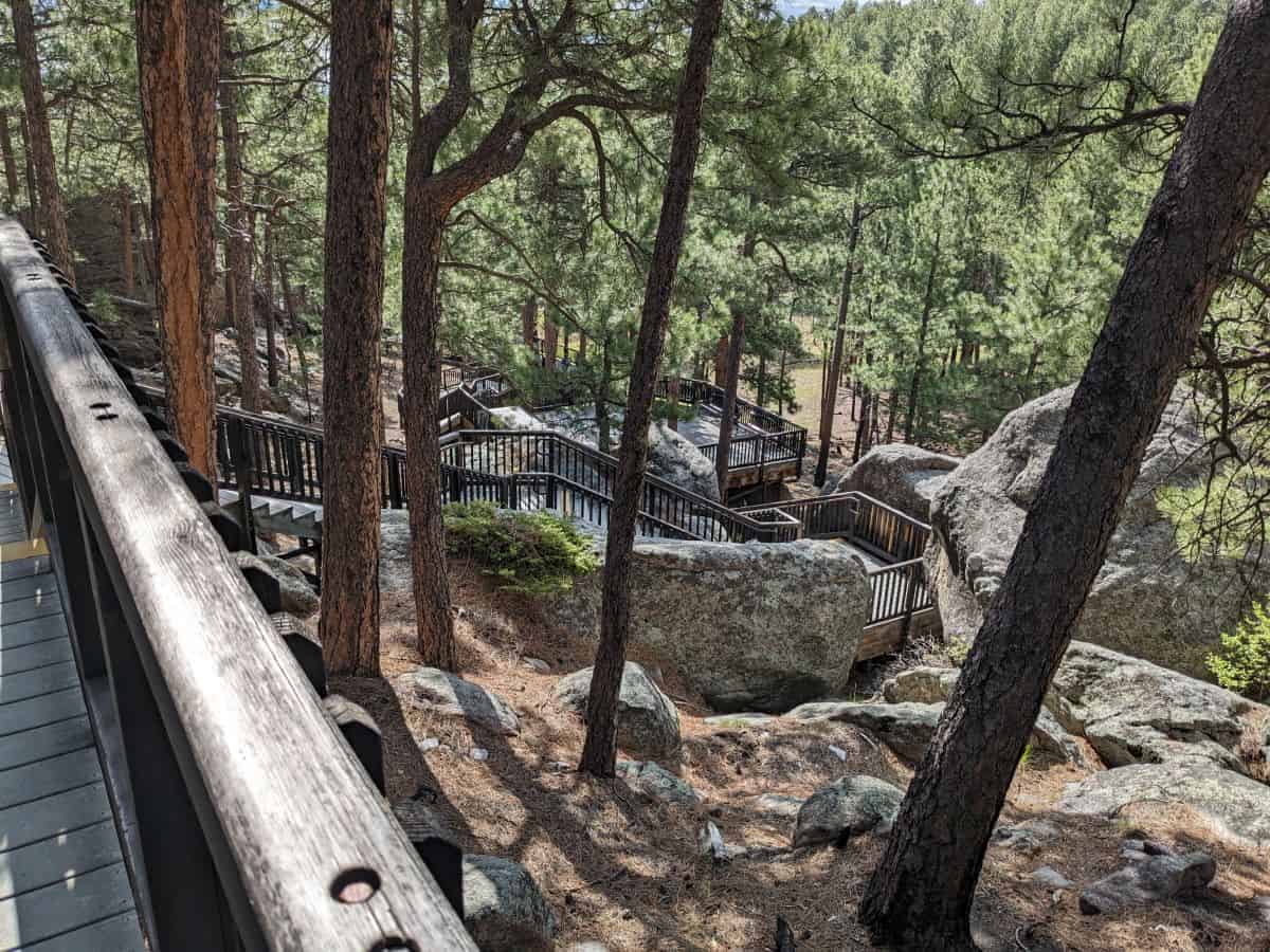 stairs descending through rocks and forest