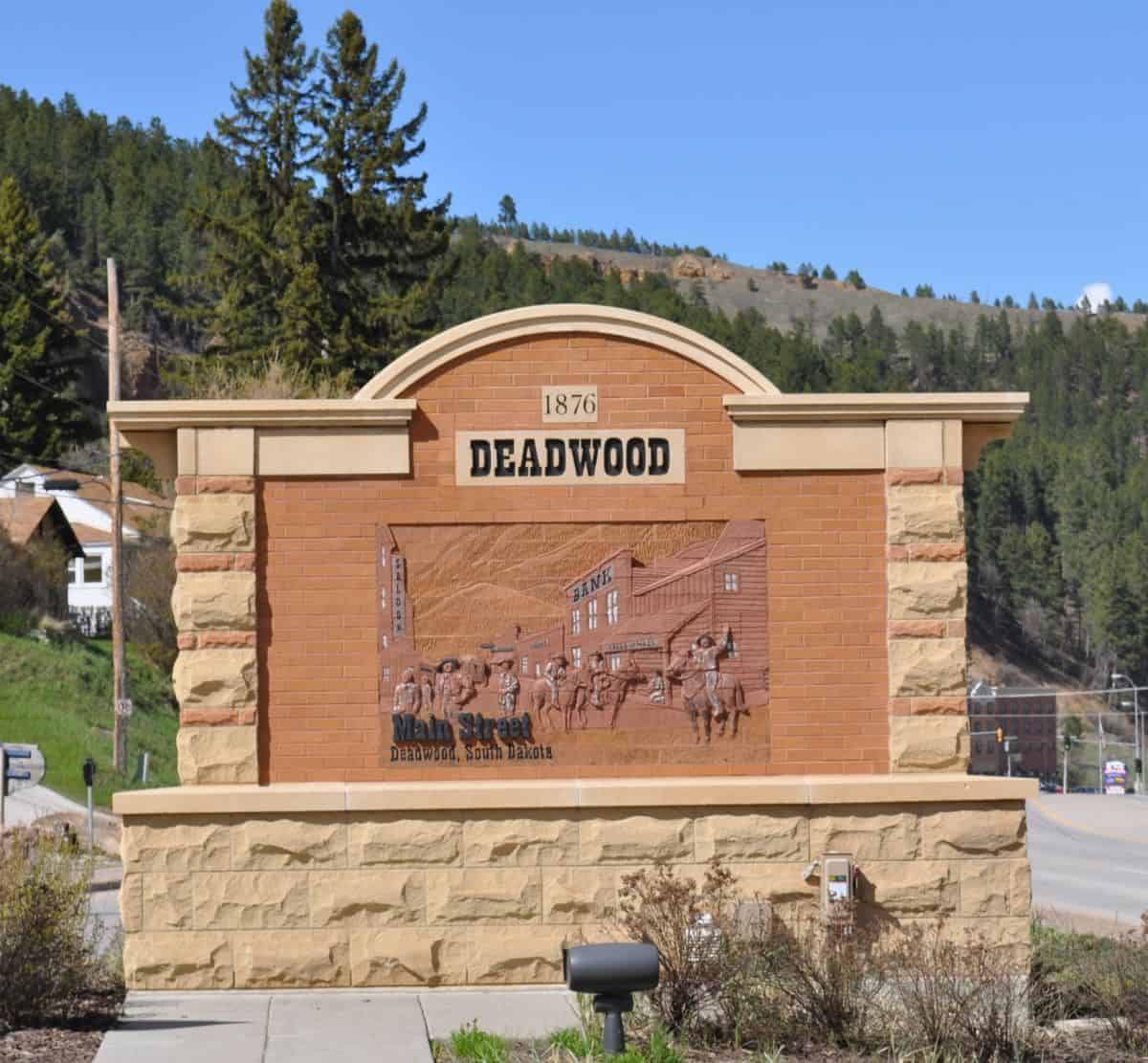 Sign with brick and stone that says Deadwood 1876