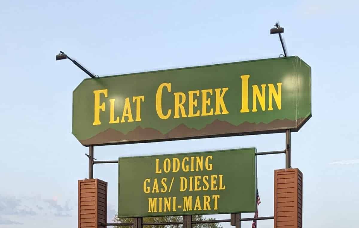 roadside motel sign that says Flat Creek Inn, lodging, gas/diesel, mini-mart