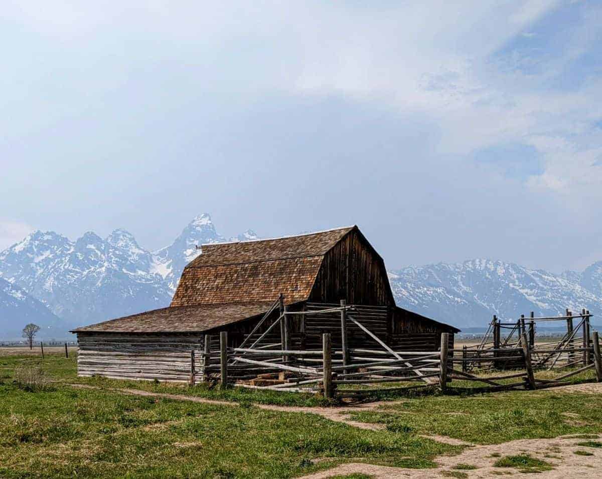 rustic barn with the Teton Range in the background