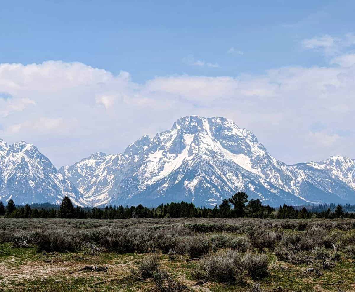 view of a large mountain with a somewhat flat top across a sagebrush plain