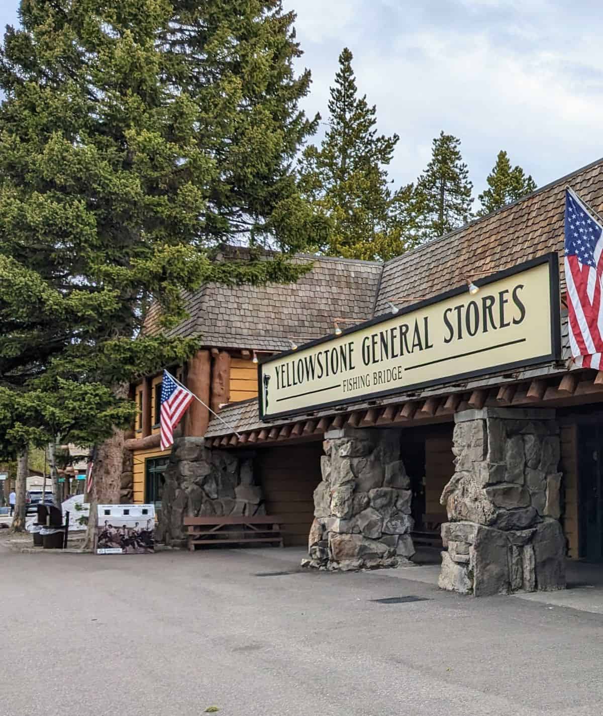 Stone and wood building with a sign that says Yellowstone General Stores Fishing Bridge.