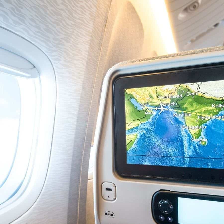 Map displayed on a screen mounted into the back of an airplane seat next to the window.